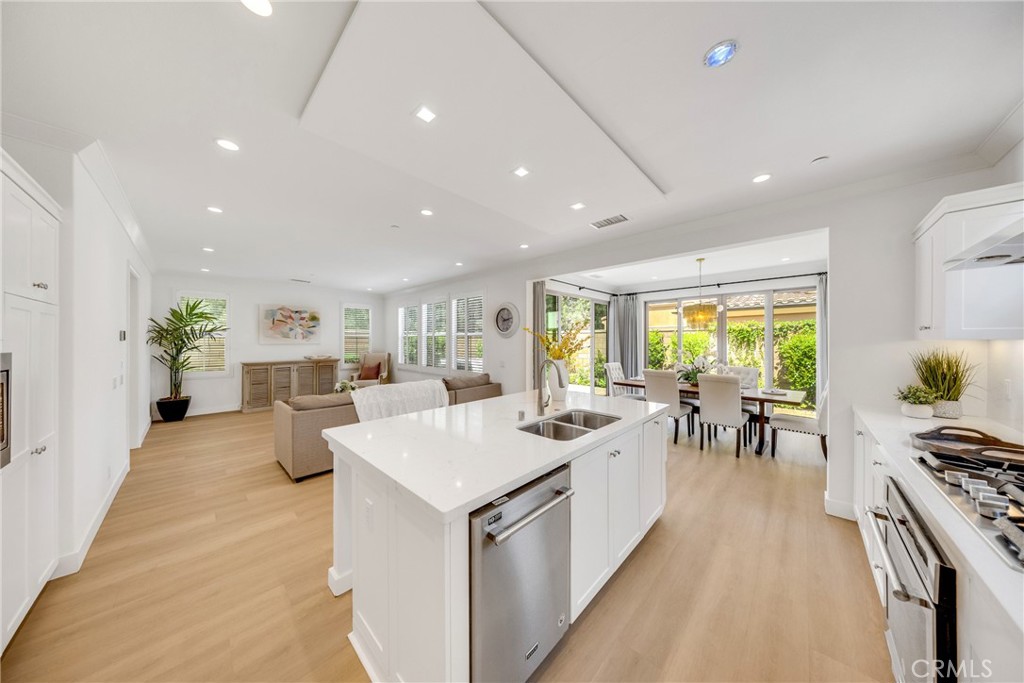 182 Frontier Irvine, CA 92620 - Photo 14 of 41 a living room with stainless steel appliances furniture a dining table and chairs
