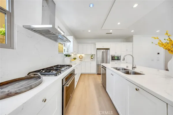 a kitchen with stainless steel appliances granite countertop a sink stove and cabinets