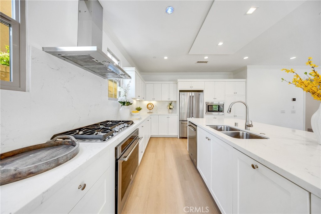 182 Frontier Irvine, CA 92620 - Photo 16 of 41 a kitchen with stainless steel appliances granite countertop a sink stove and cabinets