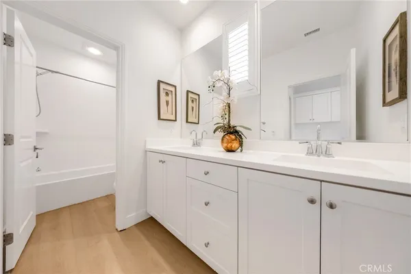 a bathroom with a sink double vanity and tub