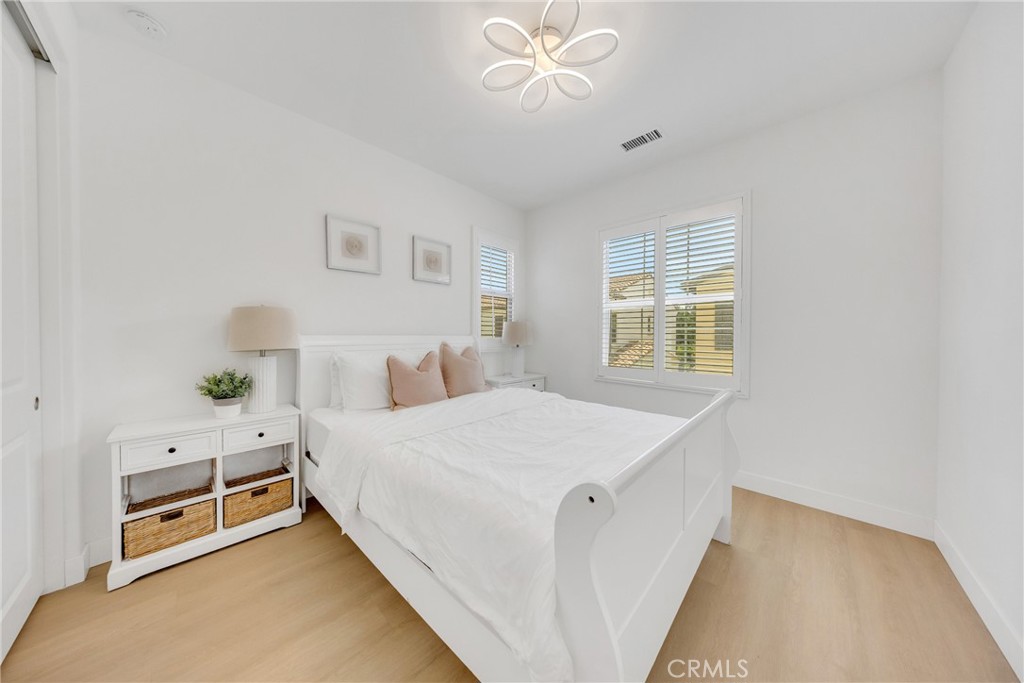 182 Frontier Irvine, CA 92620 - Photo 24 of 41 a room with a bed and a chandelier