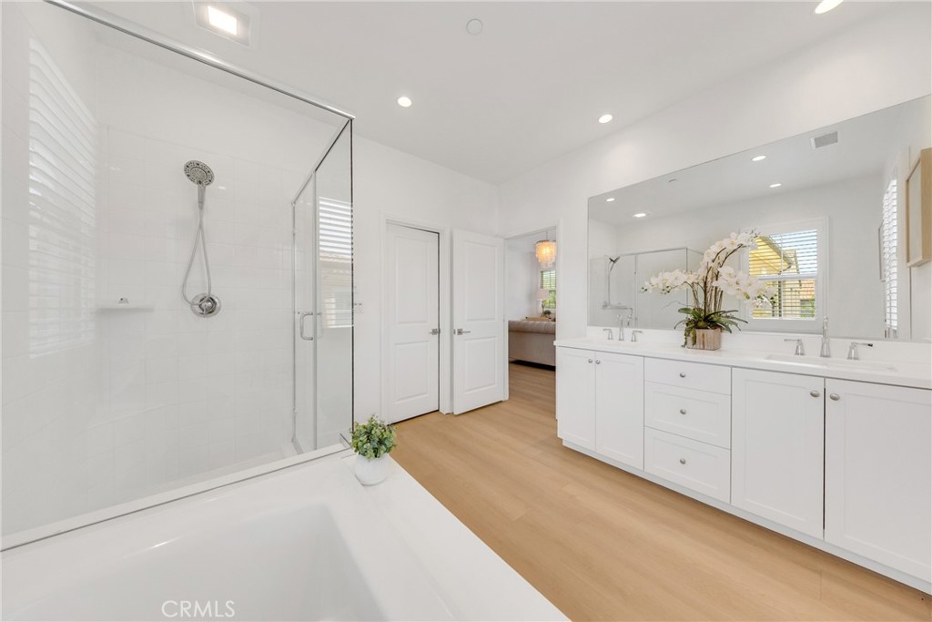 182 Frontier Irvine, CA 92620 - Photo 32 of 41 a spacious bathroom with a double vanity sink a large mirror and shower
