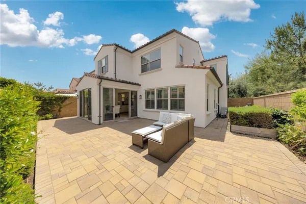 a view of a house with backyard and sitting area