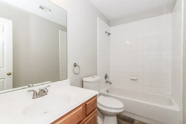 a bathroom with a sink a toilet and a bathtub