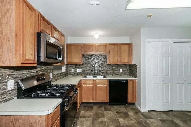 a kitchen with stainless steel appliances granite countertop a stove and a sink