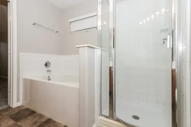 a bathroom with a bathtub and shower
