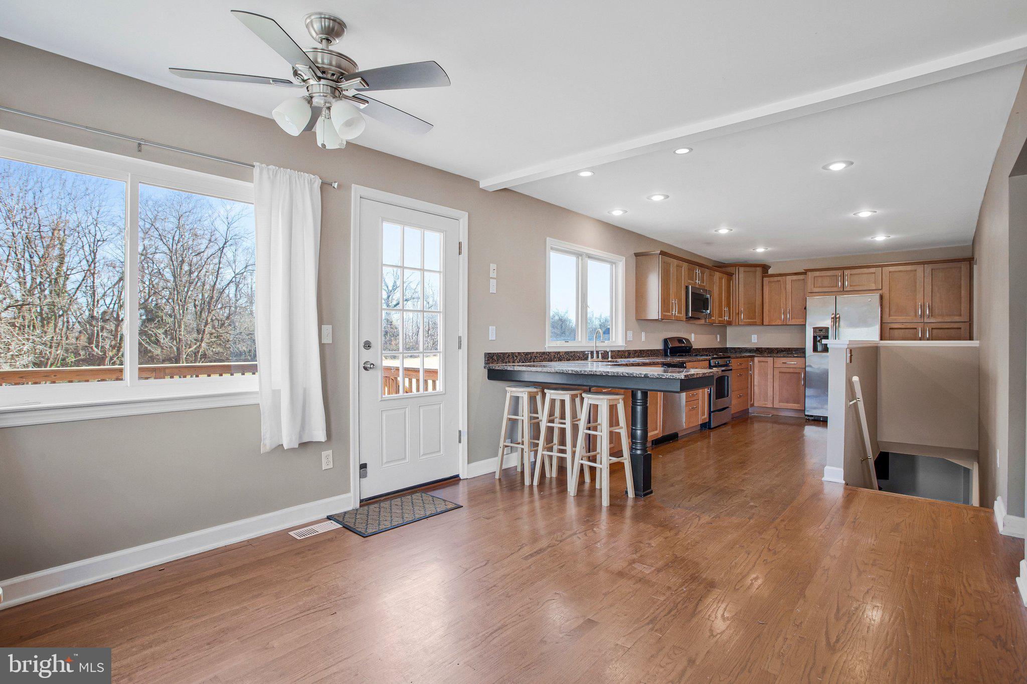 5967 Brooks Woods Road Lothian, MD 20711 - Photo 6 of 15 a view of kitchen with stainless steel appliances refrigerator oven dining table and chairs