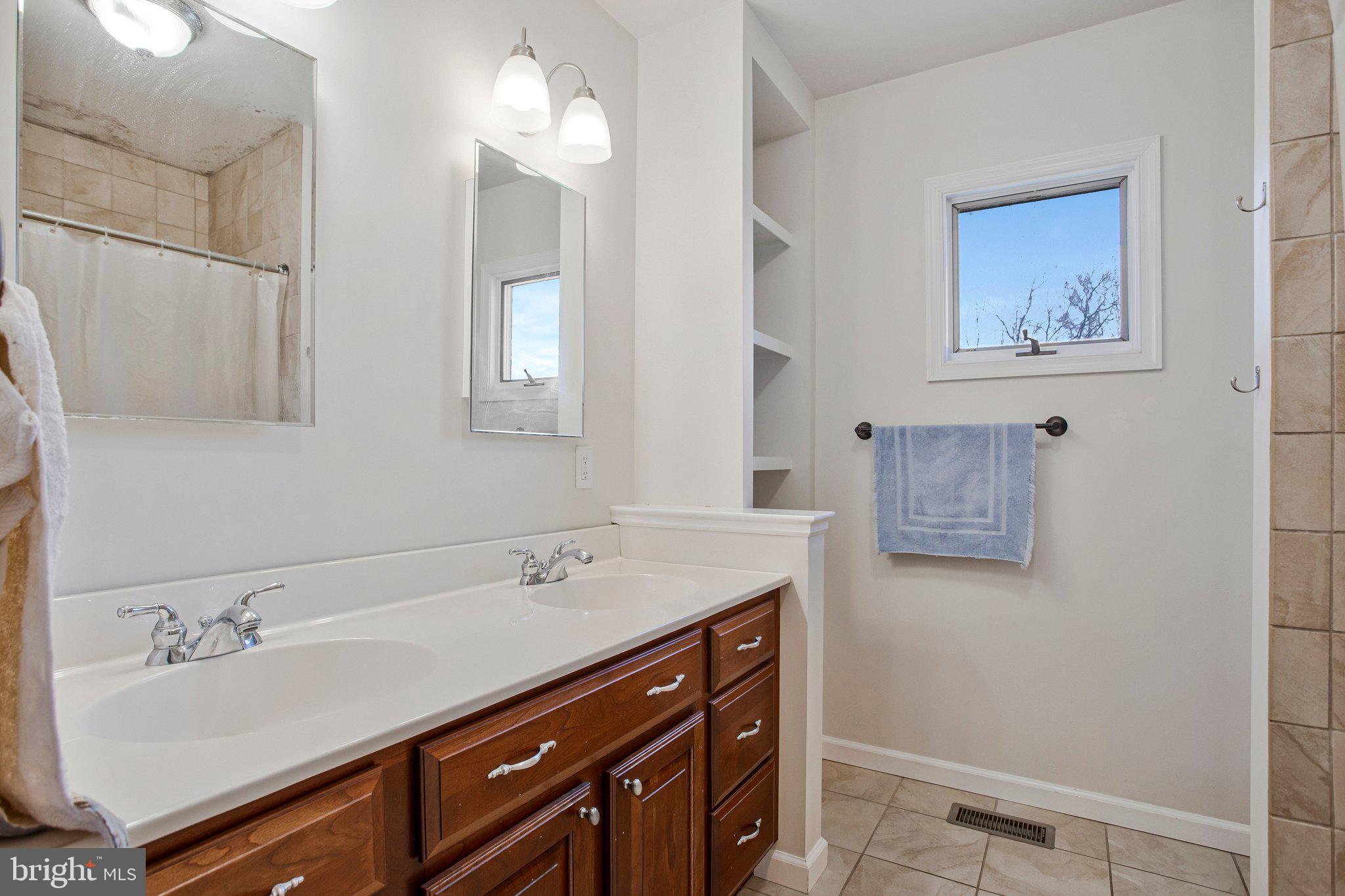 5967 Brooks Woods Road Lothian, MD 20711 - Photo 10 of 15 a bathroom with a sink and a mirror