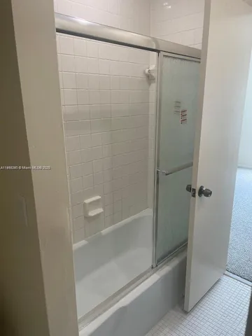 a bathroom with a glass shower door