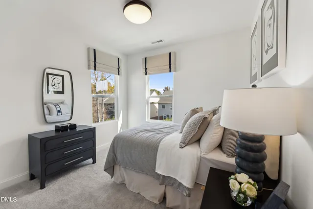 a bedroom with a bed and painting on the wall