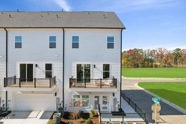 a view of a house with backyard porch and sitting area
