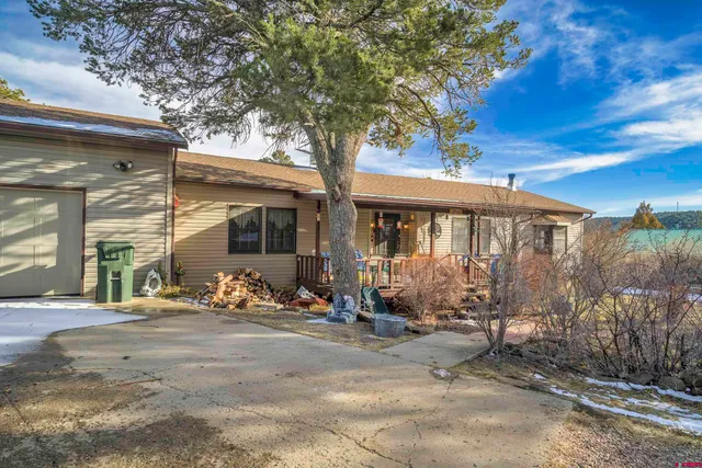 a view of a house with backyard porch and sitting area