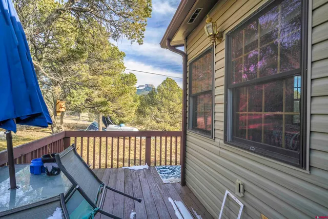 a view of balcony with wooden floor and fence