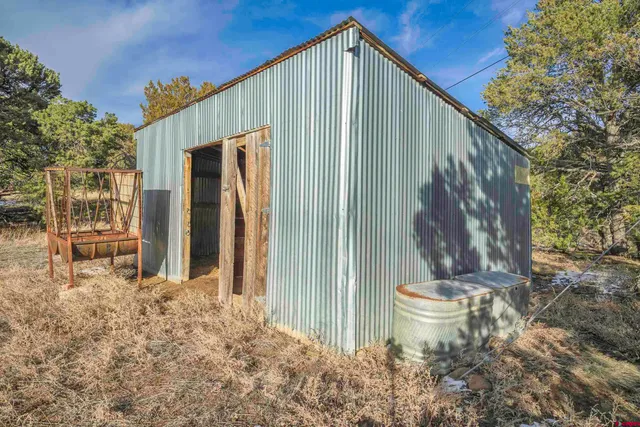a view of outdoor space with green field and trees