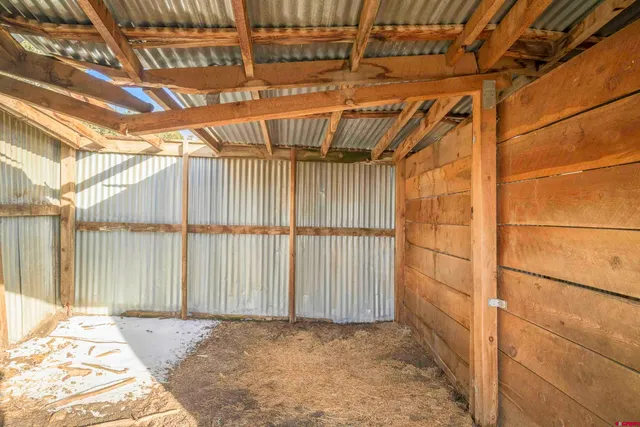 a view of a yard with wooden fence