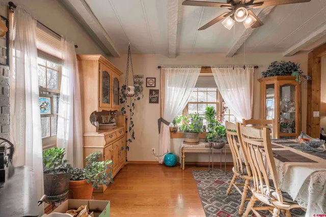 a view of a dining room with furniture a livingroom and chandelier