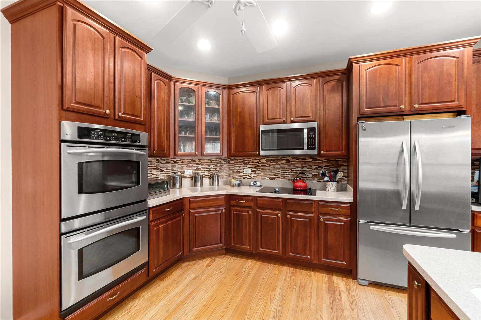 6 Winthrop New Road Sugar Grove, IL 60554 - Photo 11 of 38 a kitchen with stainless steel appliances granite countertop a stove microwave and refrigerator