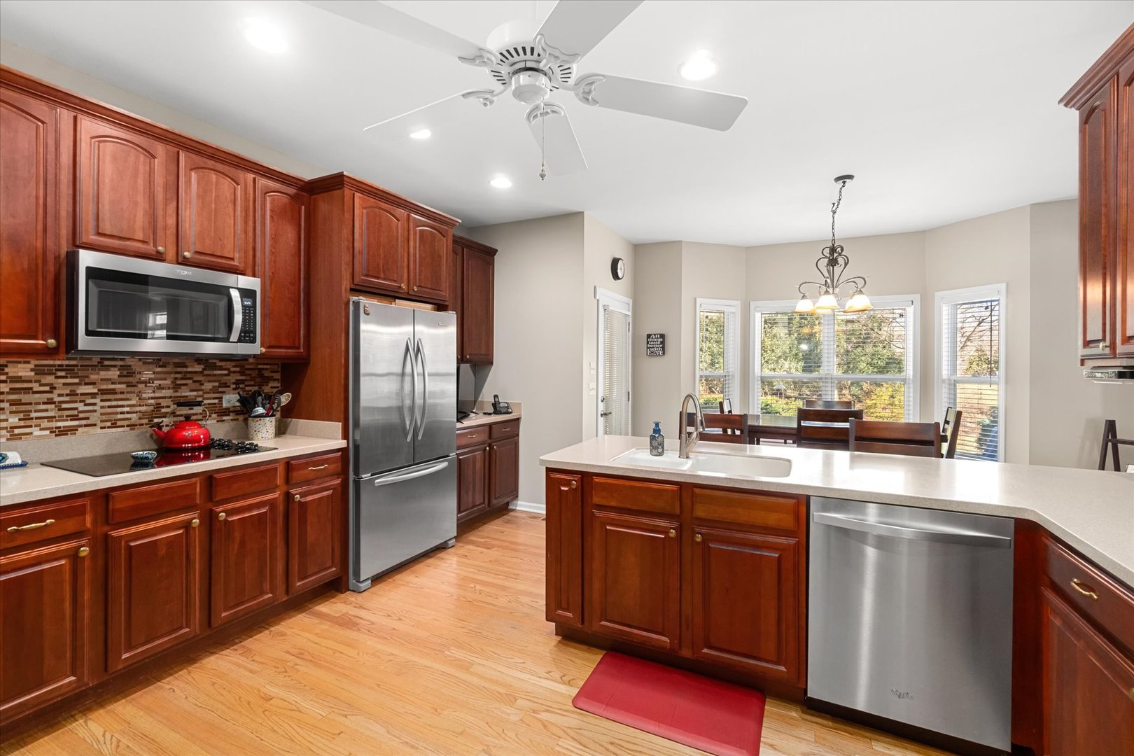 6 Winthrop New Road Sugar Grove, IL 60554 - Photo 10 of 38 a kitchen with stainless steel appliances granite countertop a sink a stove top oven and refrigerator