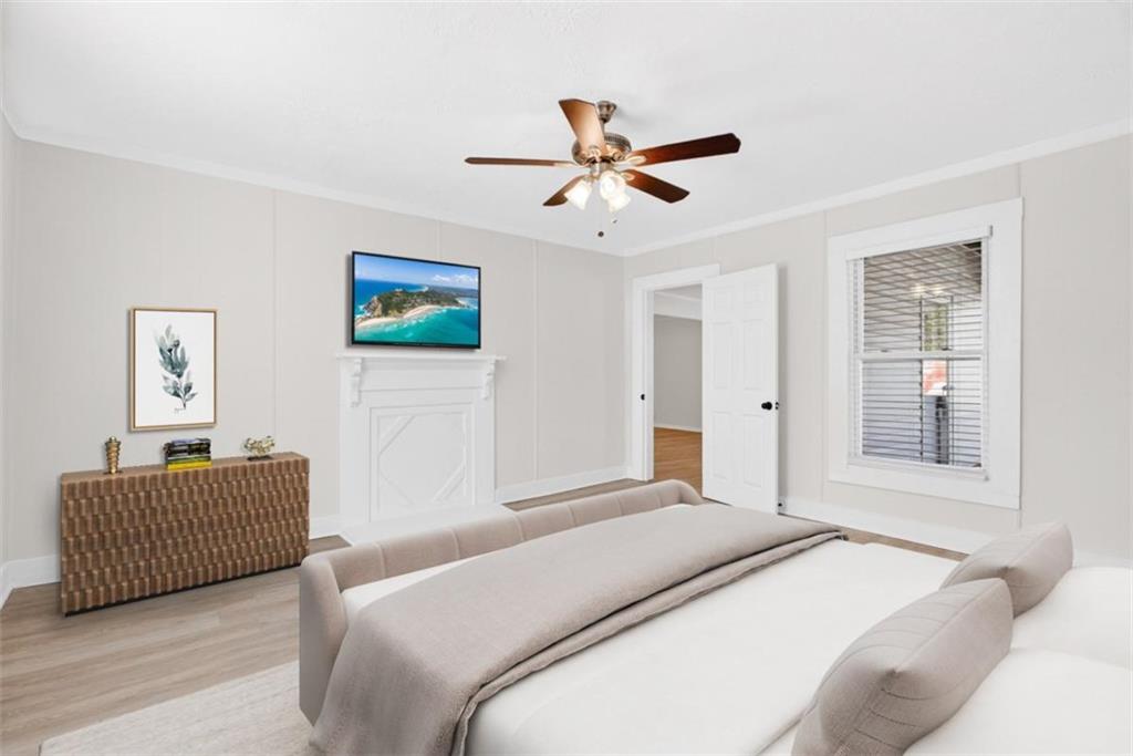 246 Spring Street Commerce, GA 30529 - Photo 18 of 23 a bedroom with a bed and a chandelier