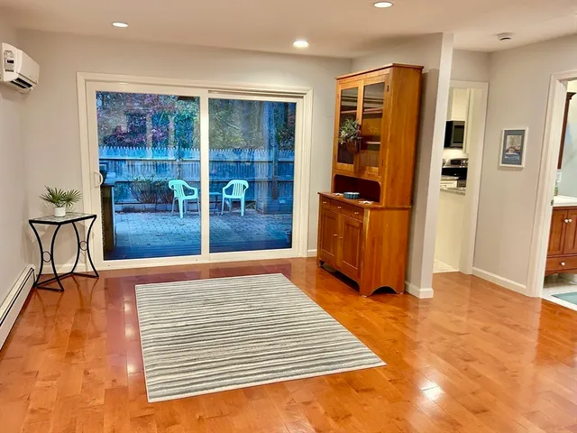 a view of a bedroom with furniture and window
