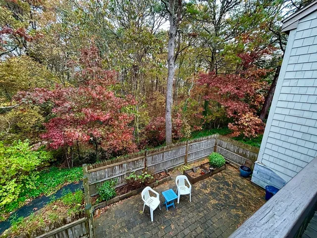 a backyard of a house with table and chairs