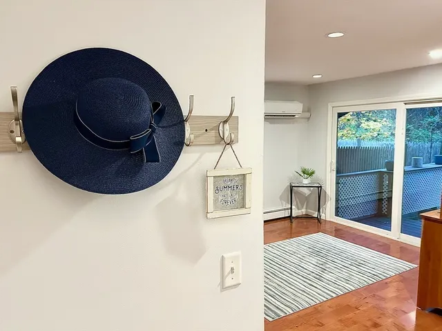 a living room with a rug and a wooden floor