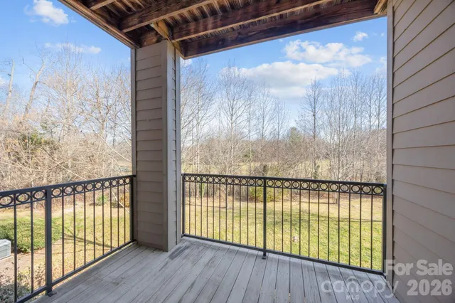 a view of a balcony with wooden floor