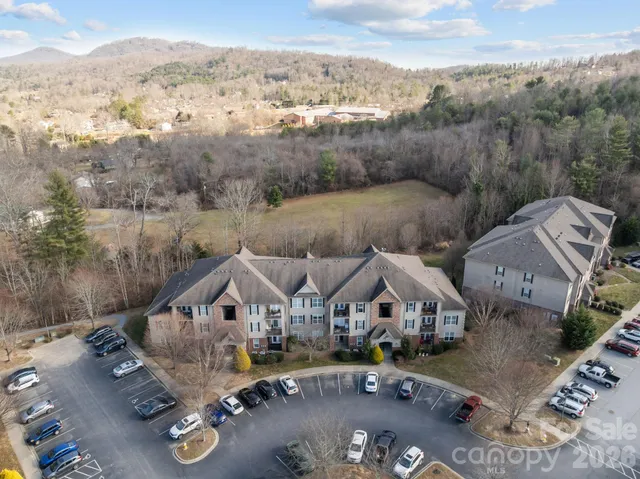 an aerial view of a house with a big yard