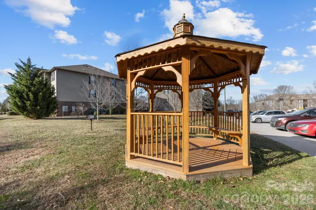 a view of a small house with a yard