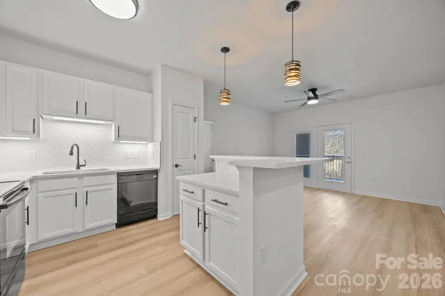 a kitchen with white cabinets and white appliances