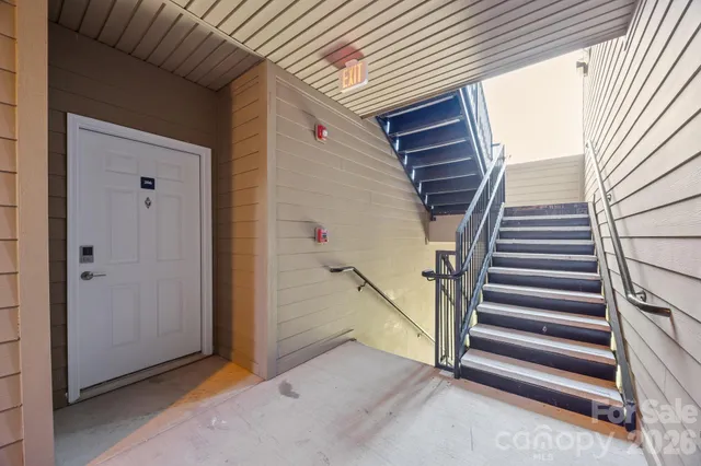 a view of a house with wooden floor and white walls