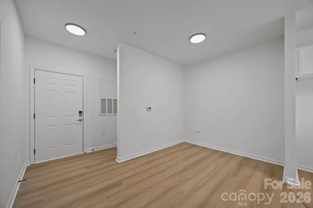 a view of an empty room with wooden floor