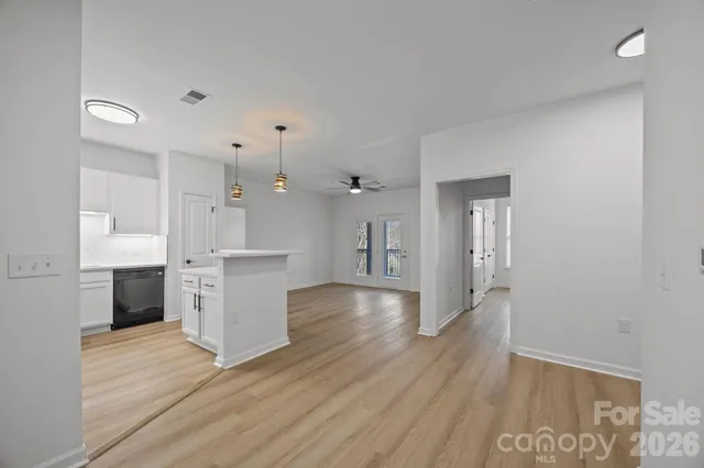 a view of kitchen with wooden floor and electronic appliances