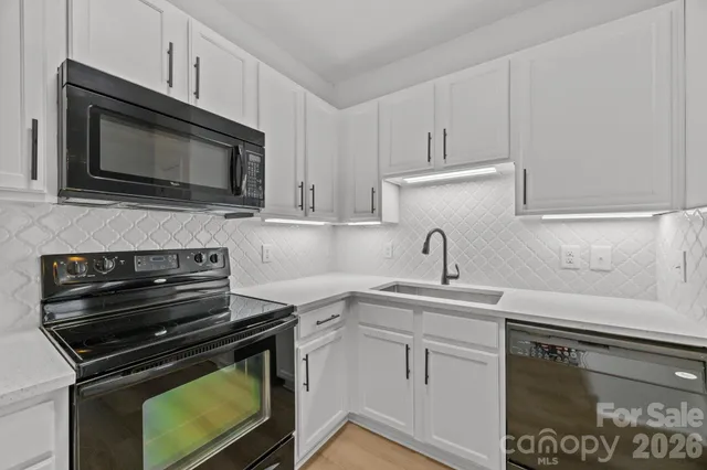a kitchen with cabinets stainless steel appliances and a sink