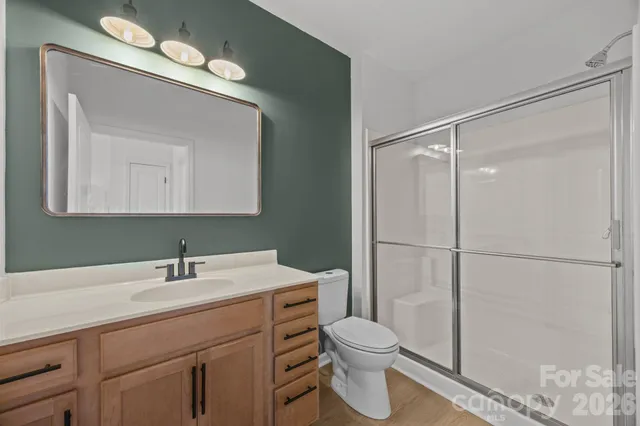 a bathroom with a toilet a sink a vanity and mirror