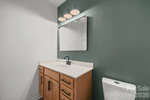 a bathroom with a sink toilet and mirror