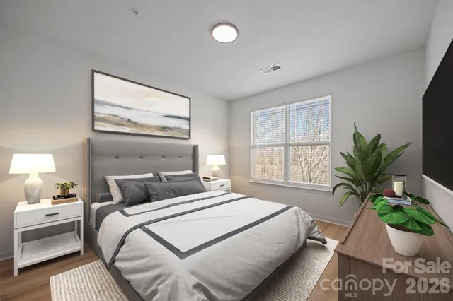 a bedroom with a bed and a potted plant