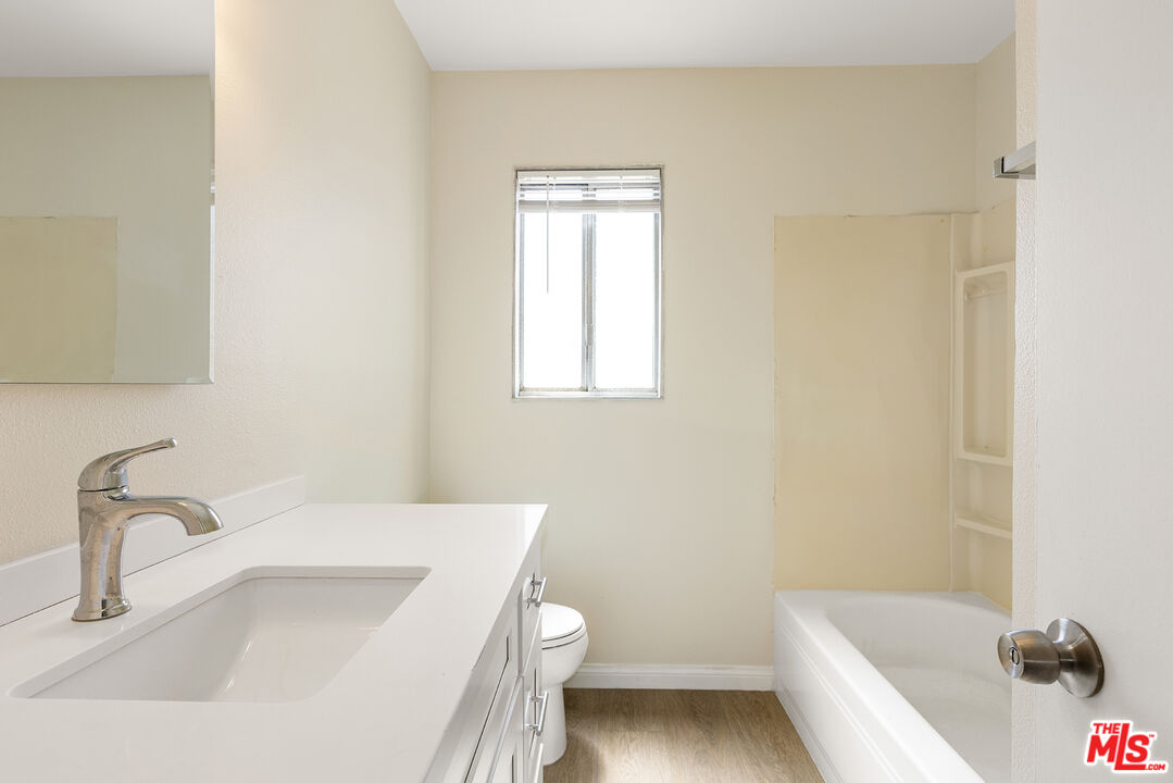 19115 Nestor Avenue Carson, CA 90746 - Photo 12 of 22 a bathroom with a sink a toilet and bathtub