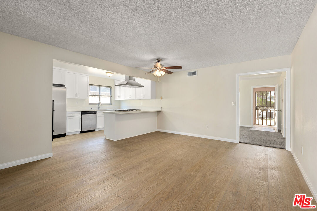 19115 Nestor Avenue Carson, CA 90746 - Photo 3 of 22 a view of a kitchen with a sink cabinets and wooden floor