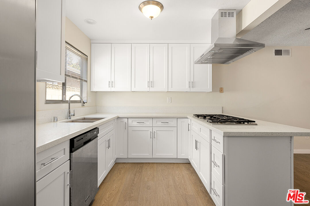 19115 Nestor Avenue Carson, CA 90746 - Photo 7 of 22 a kitchen with cabinets appliances a sink and a window