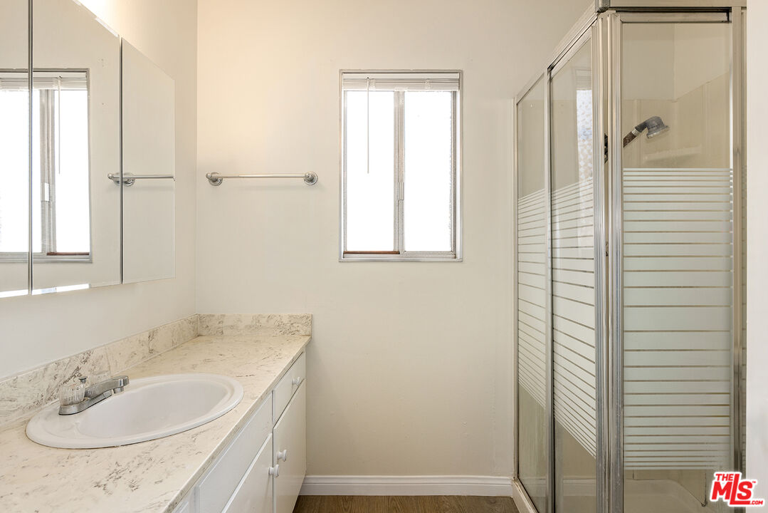 19115 Nestor Avenue Carson, CA 90746 - Photo 10 of 22 a bathroom with a granite countertop sink and a mirror