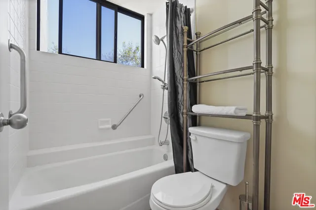 a bathroom with a sink vanity mirror and toilet