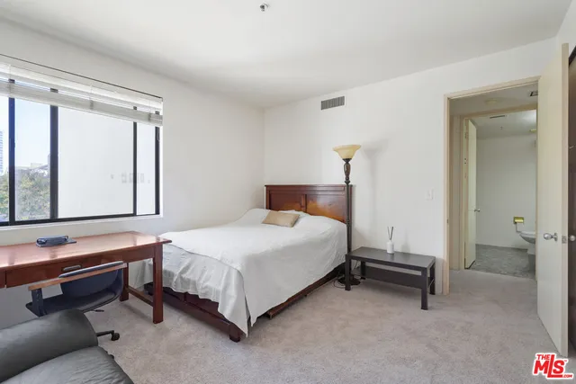 a view of a living room with furniture and a flat screen tv