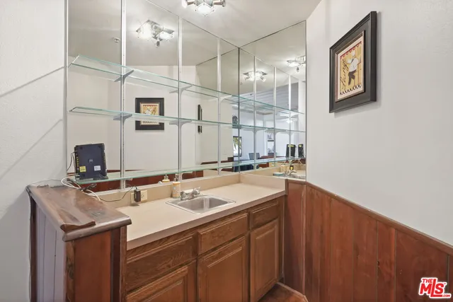 a kitchen with stainless steel appliances a stove a sink and a microwave