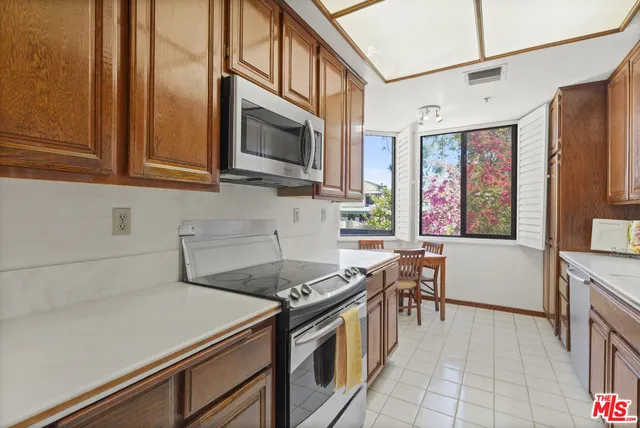 a view of living room with furniture and a refrigerator