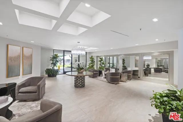 a living room with fireplace furniture and a large window
