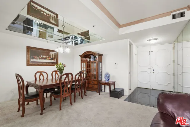 a living room with furniture large window and glass door