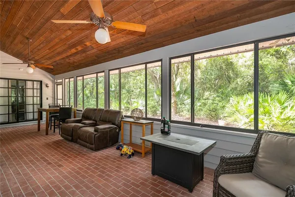 a living room with furniture and large windows
