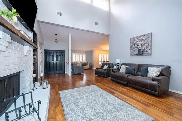 a living room with furniture wooden floor and a fireplace