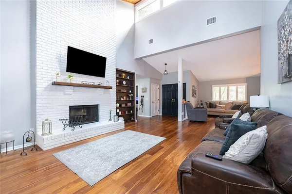a living room with furniture fireplace and flat screen tv